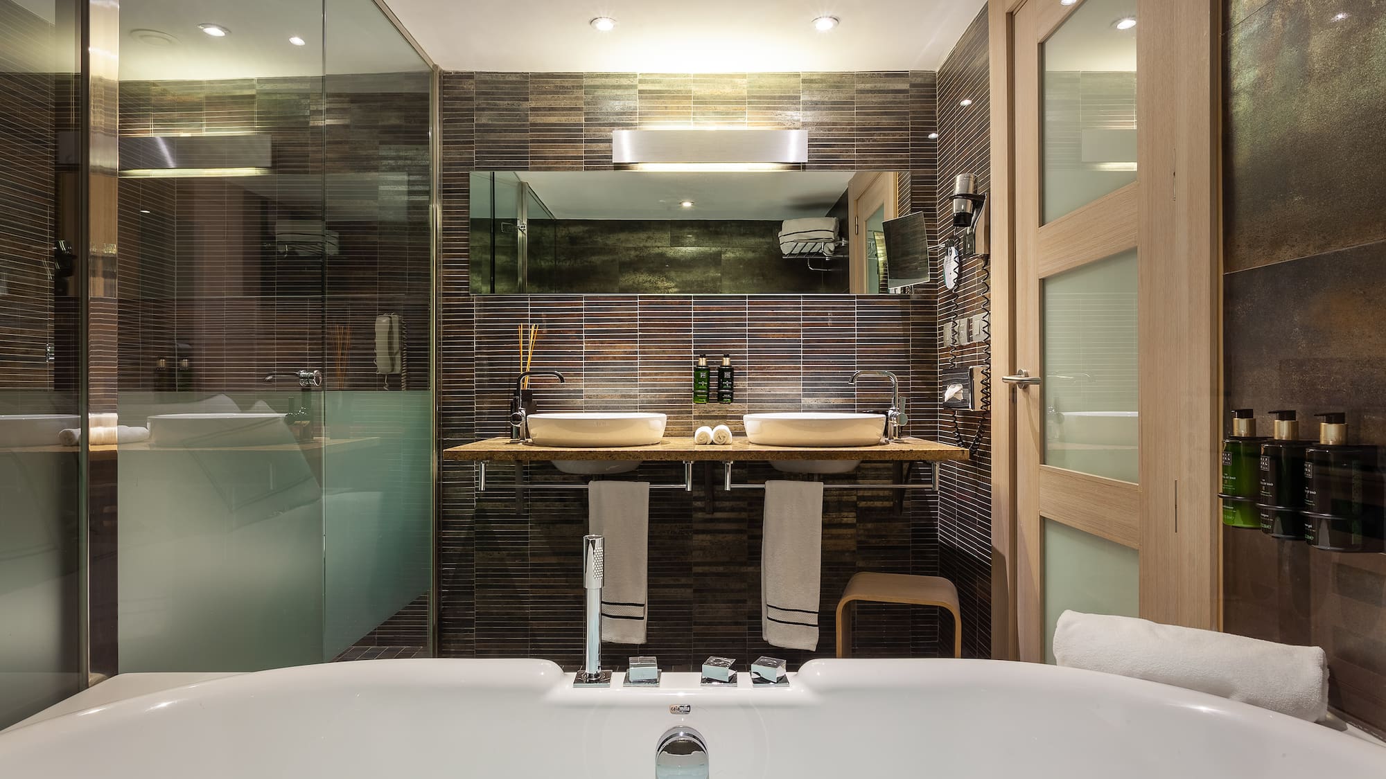 a bathroom with a tub and a shower