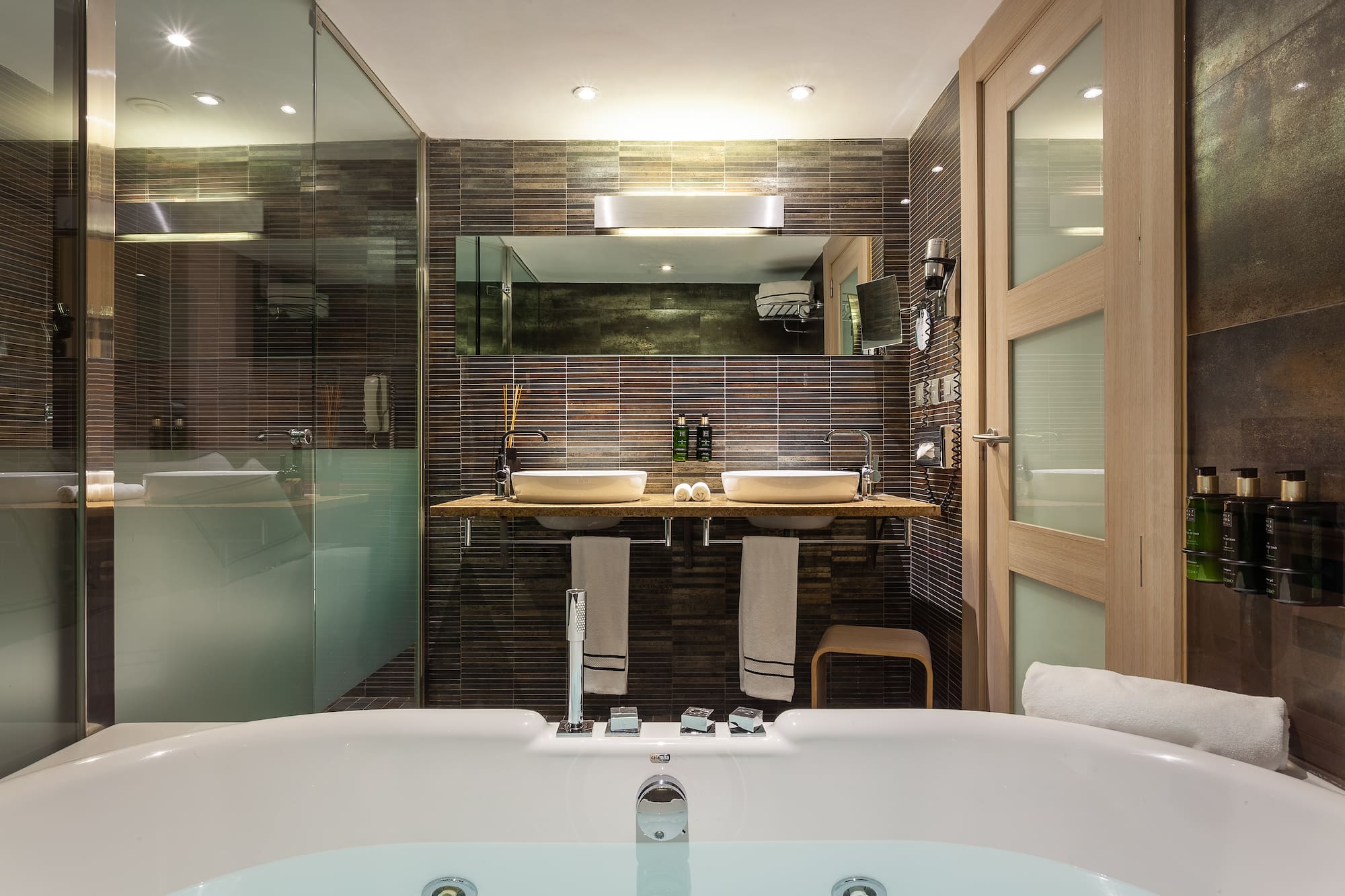 a bathroom with a tub and a shower