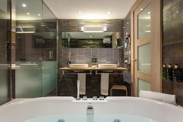 a bathroom with a tub and a shower