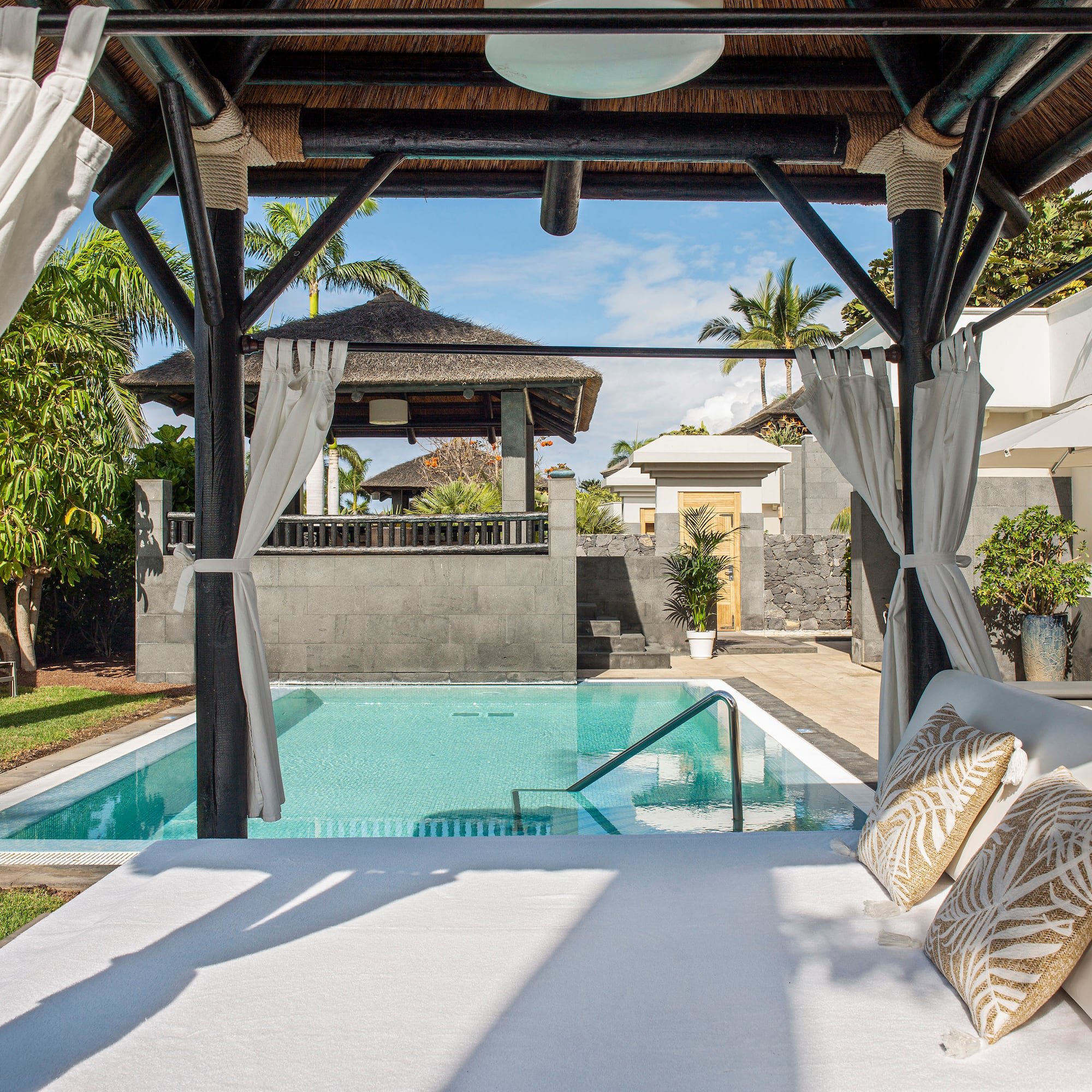 a pool with a bed and pillows