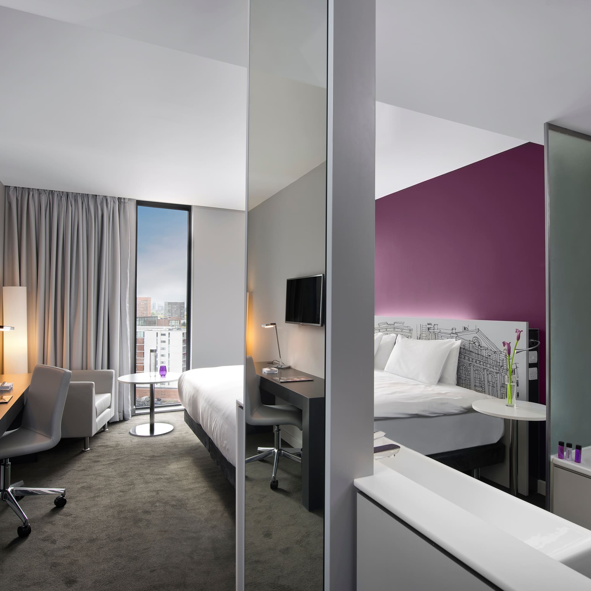 a room with a bed and a desk