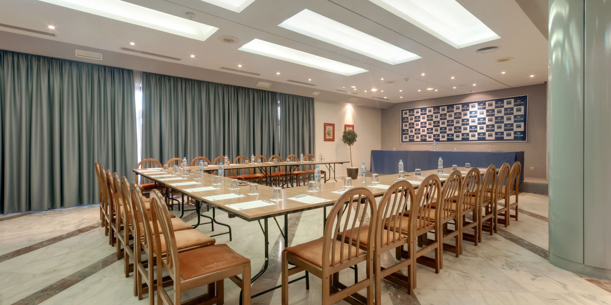 a room with a long table and chairs