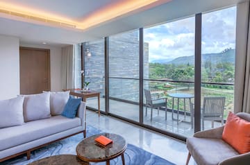 a living room with a glass wall and a couch