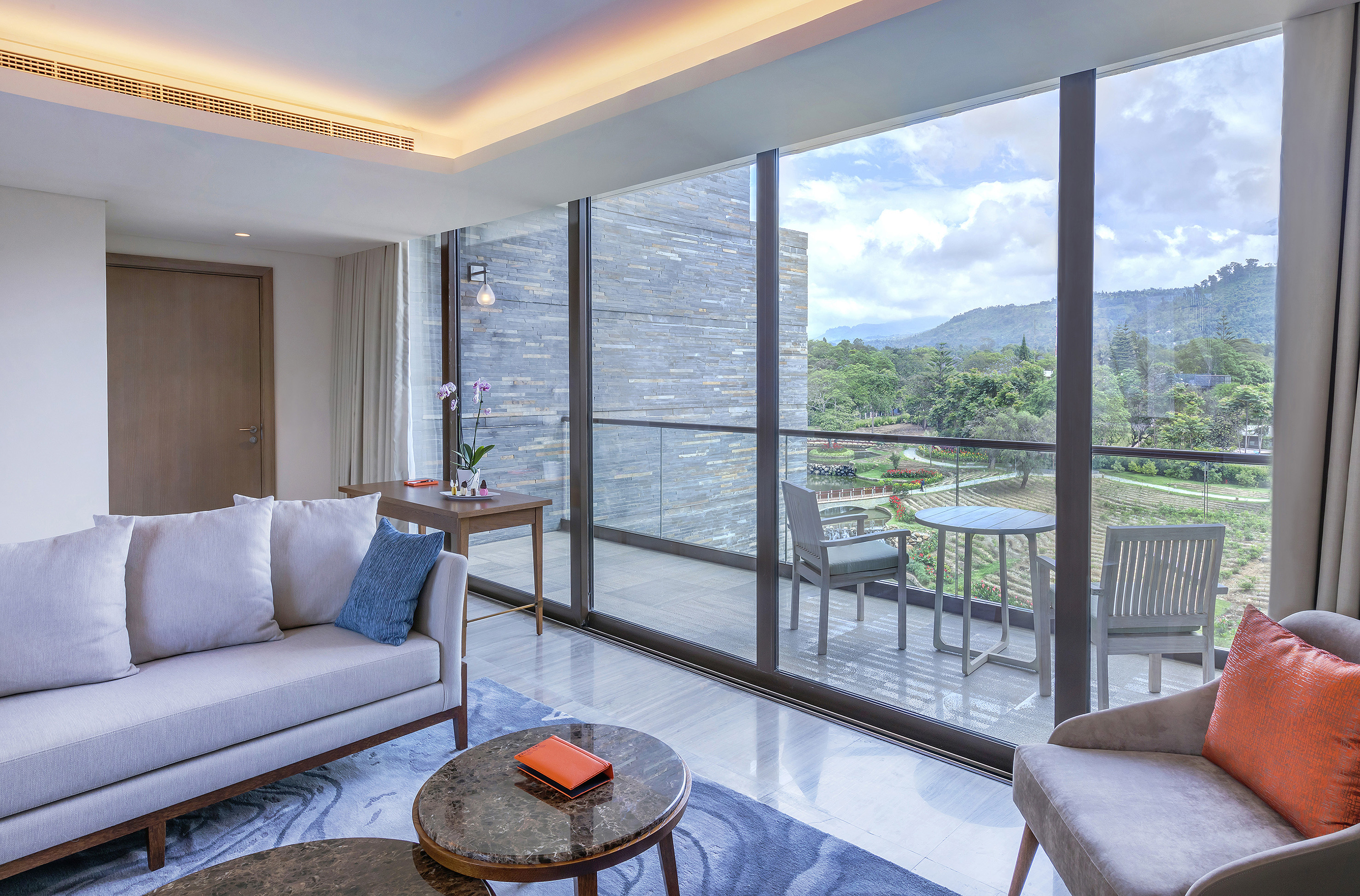 a living room with a glass wall and a couch