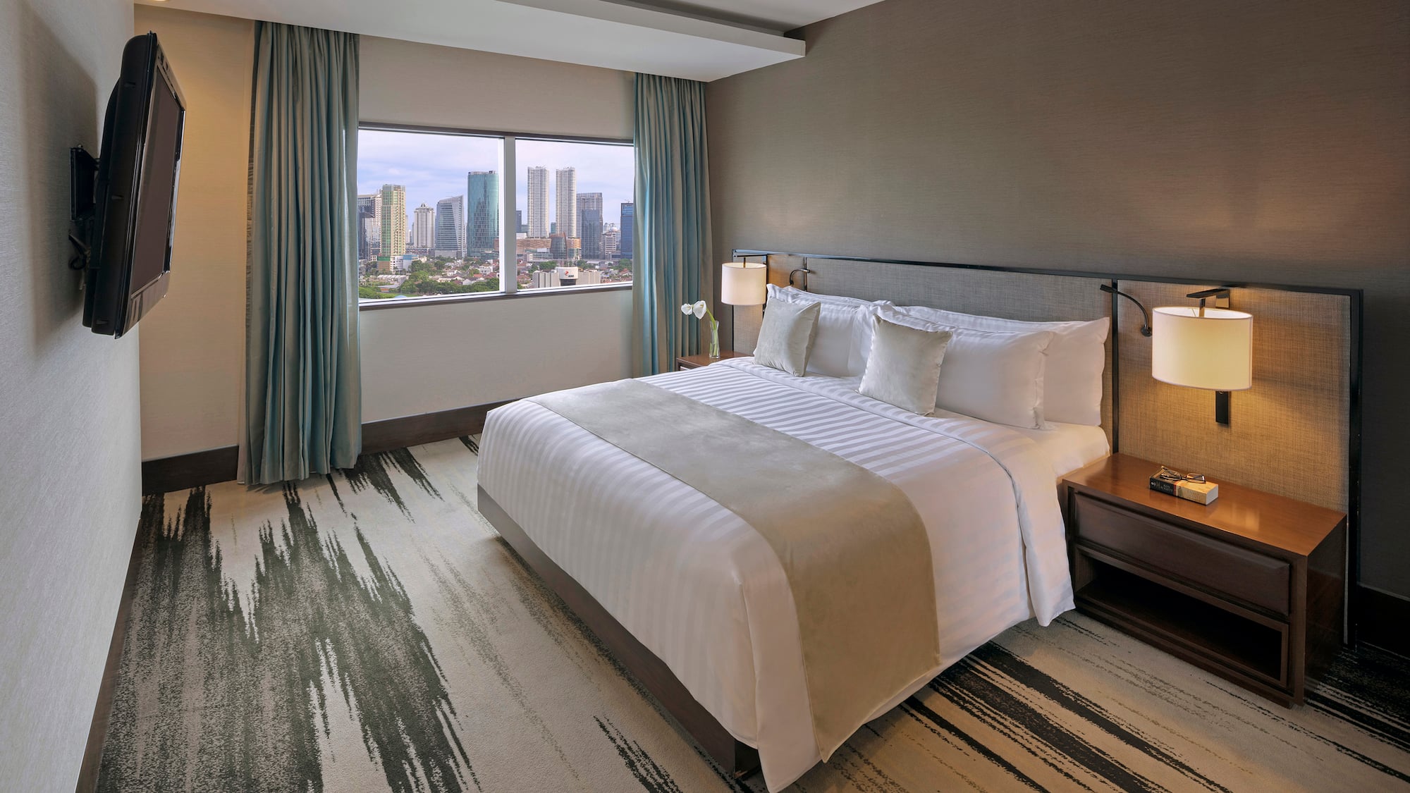 a hotel room with a large bed and a window