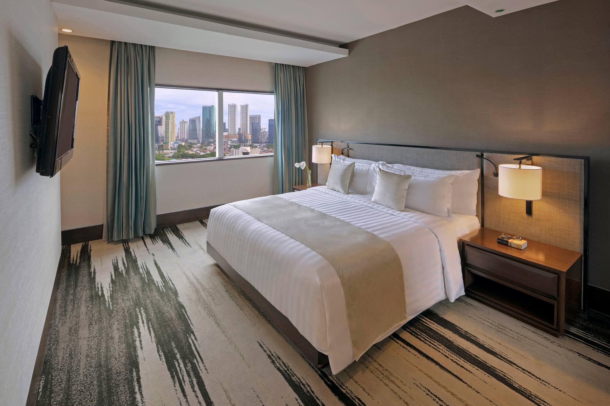 a hotel room with a large bed and a window