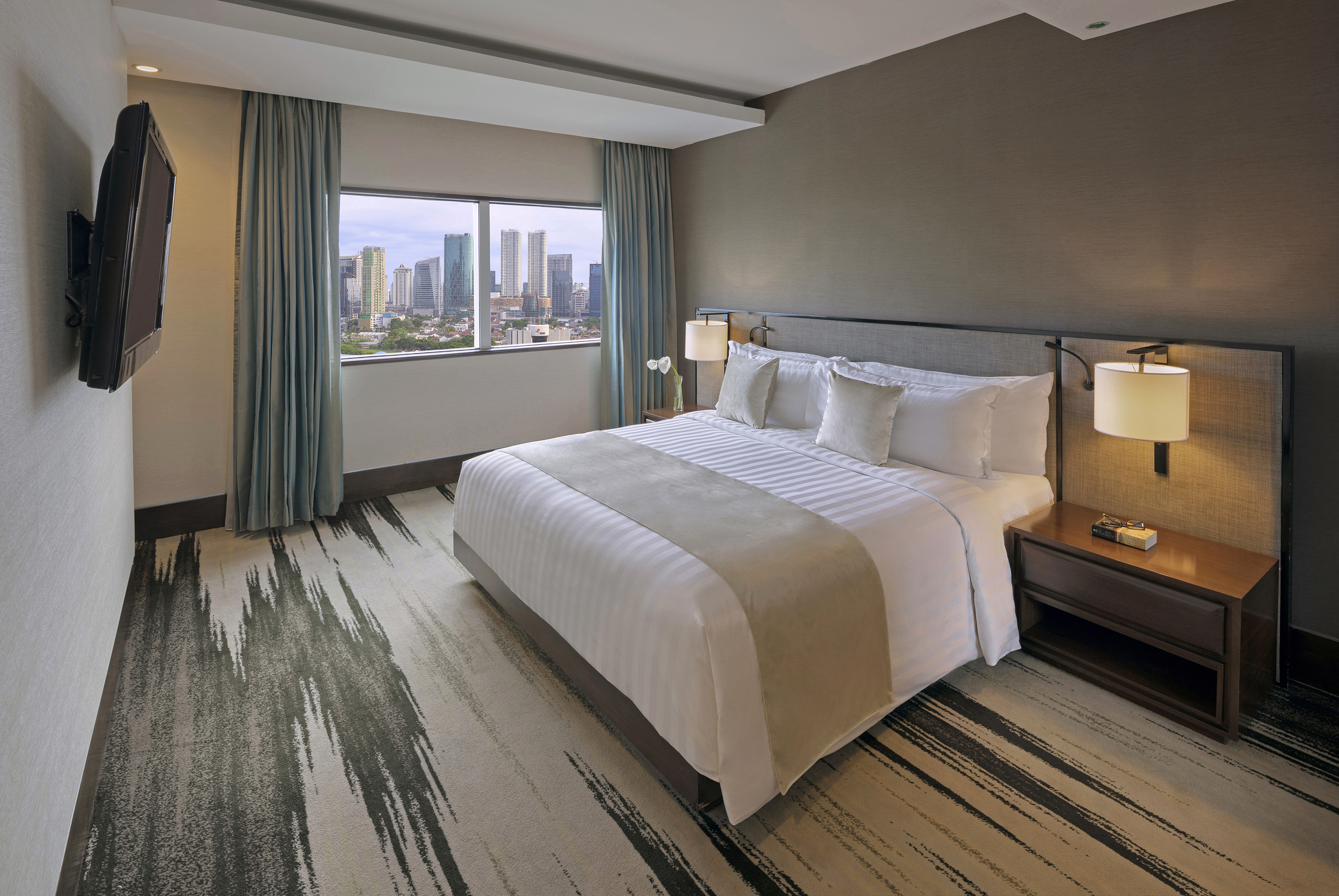 a hotel room with a large bed and a window