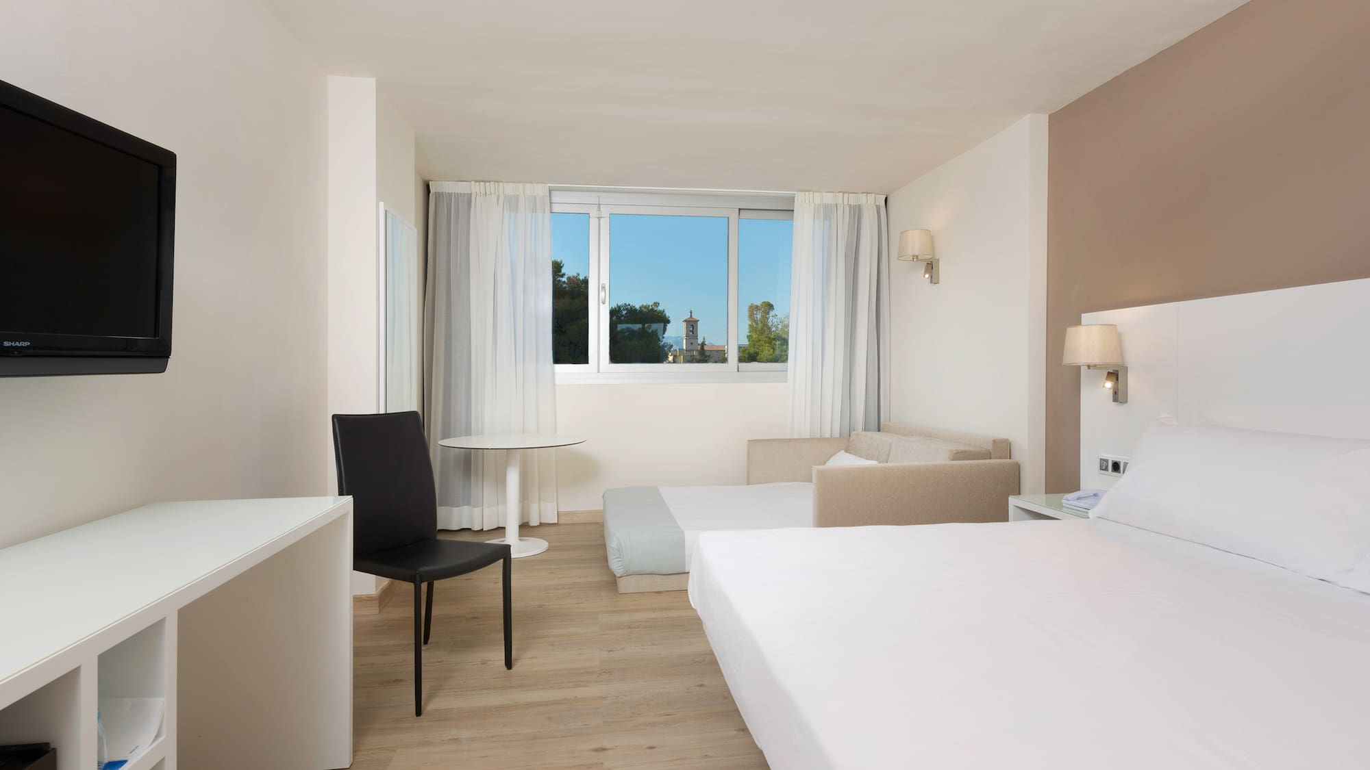 a room with two beds and a table