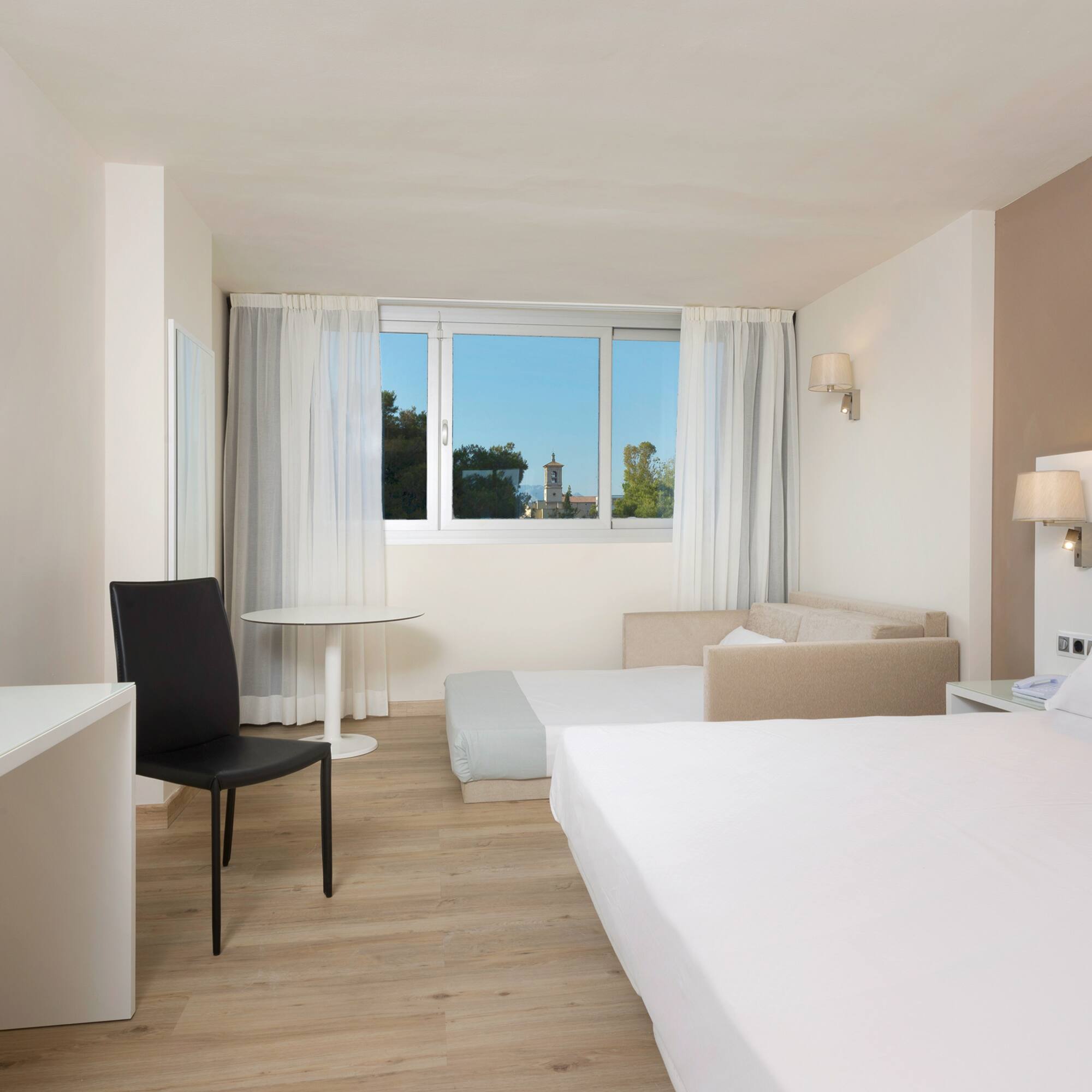 a room with two beds and a table