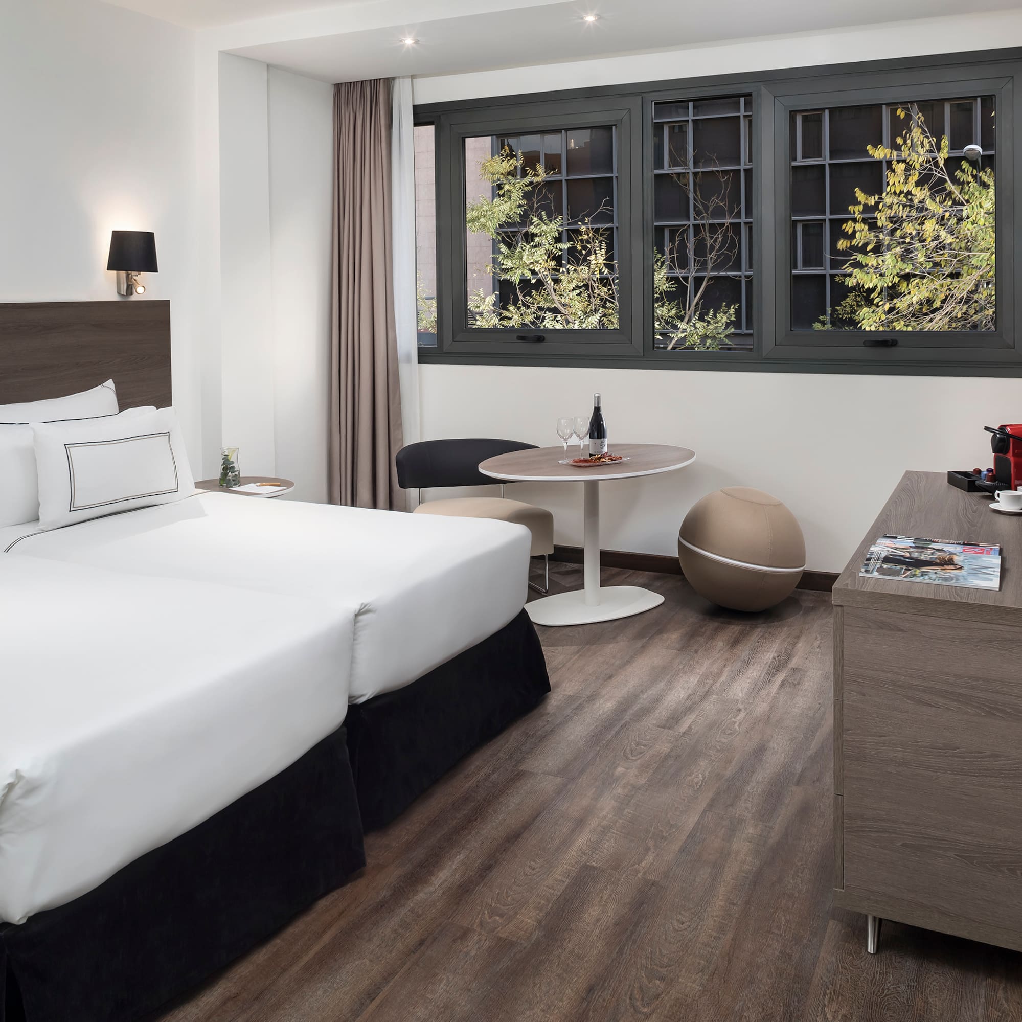 a room with two beds and a table