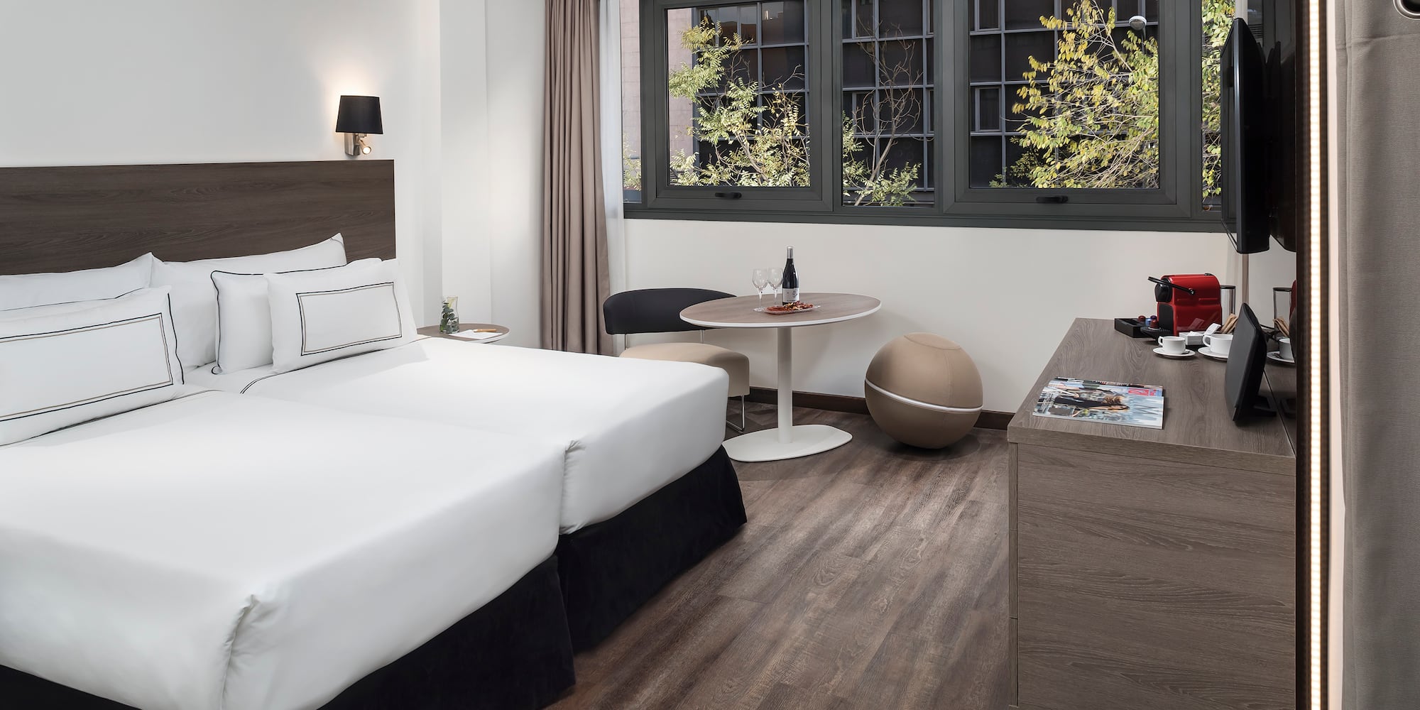 a room with two beds and a table