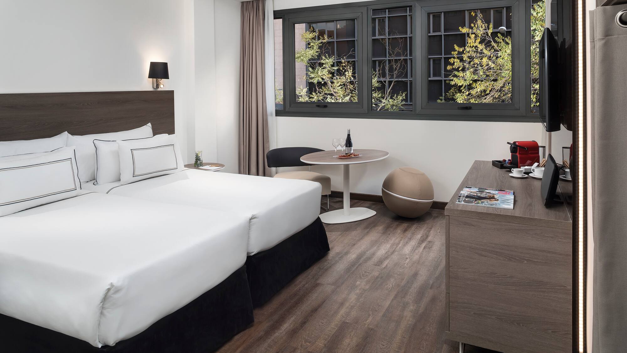 a room with two beds and a table