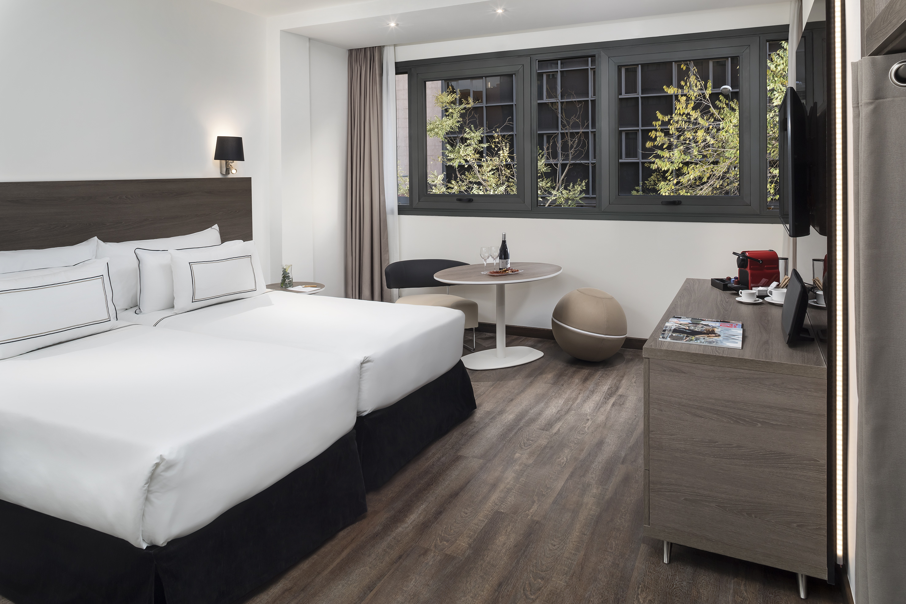 a room with two beds and a table