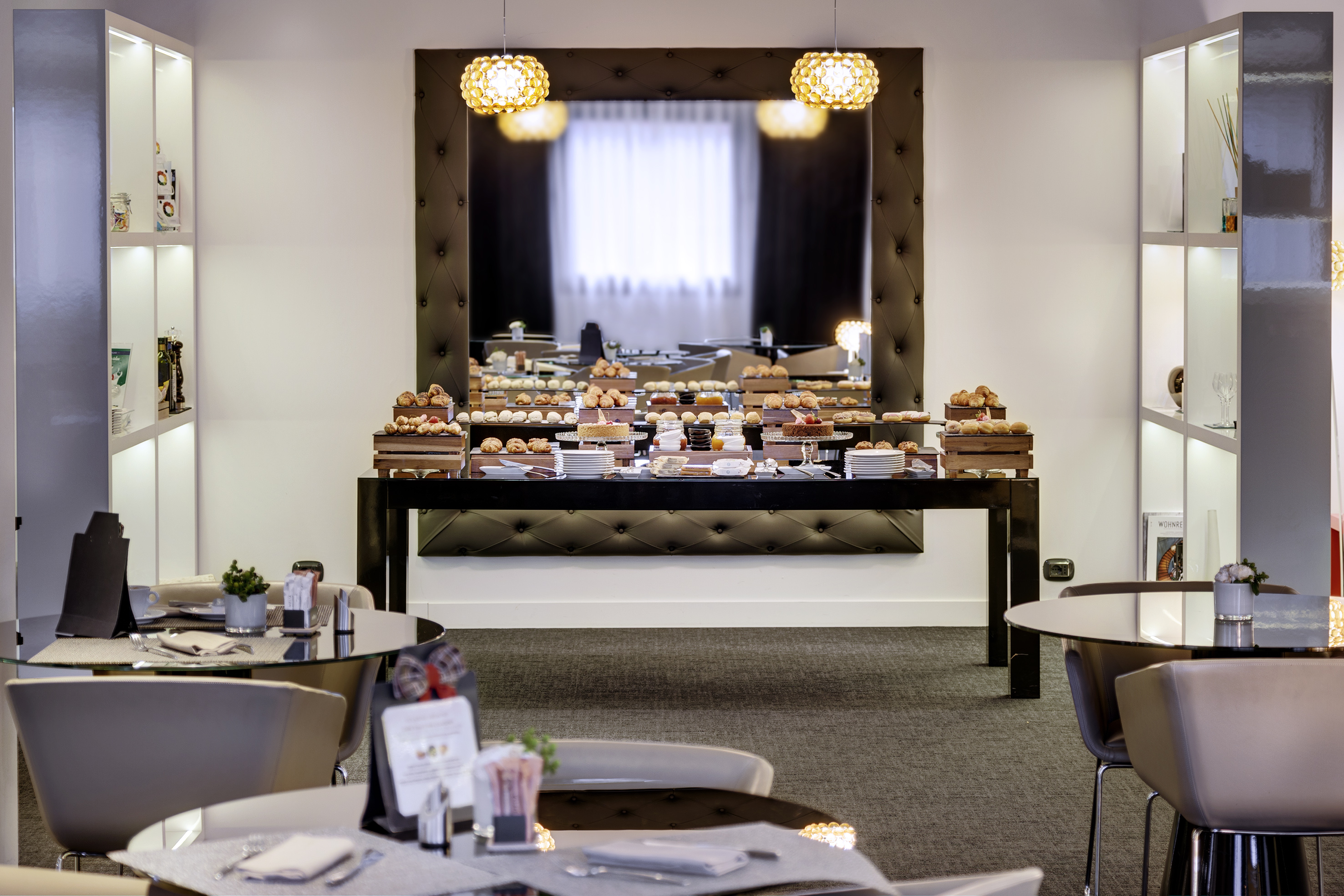 a room with tables and chairs and a mirror