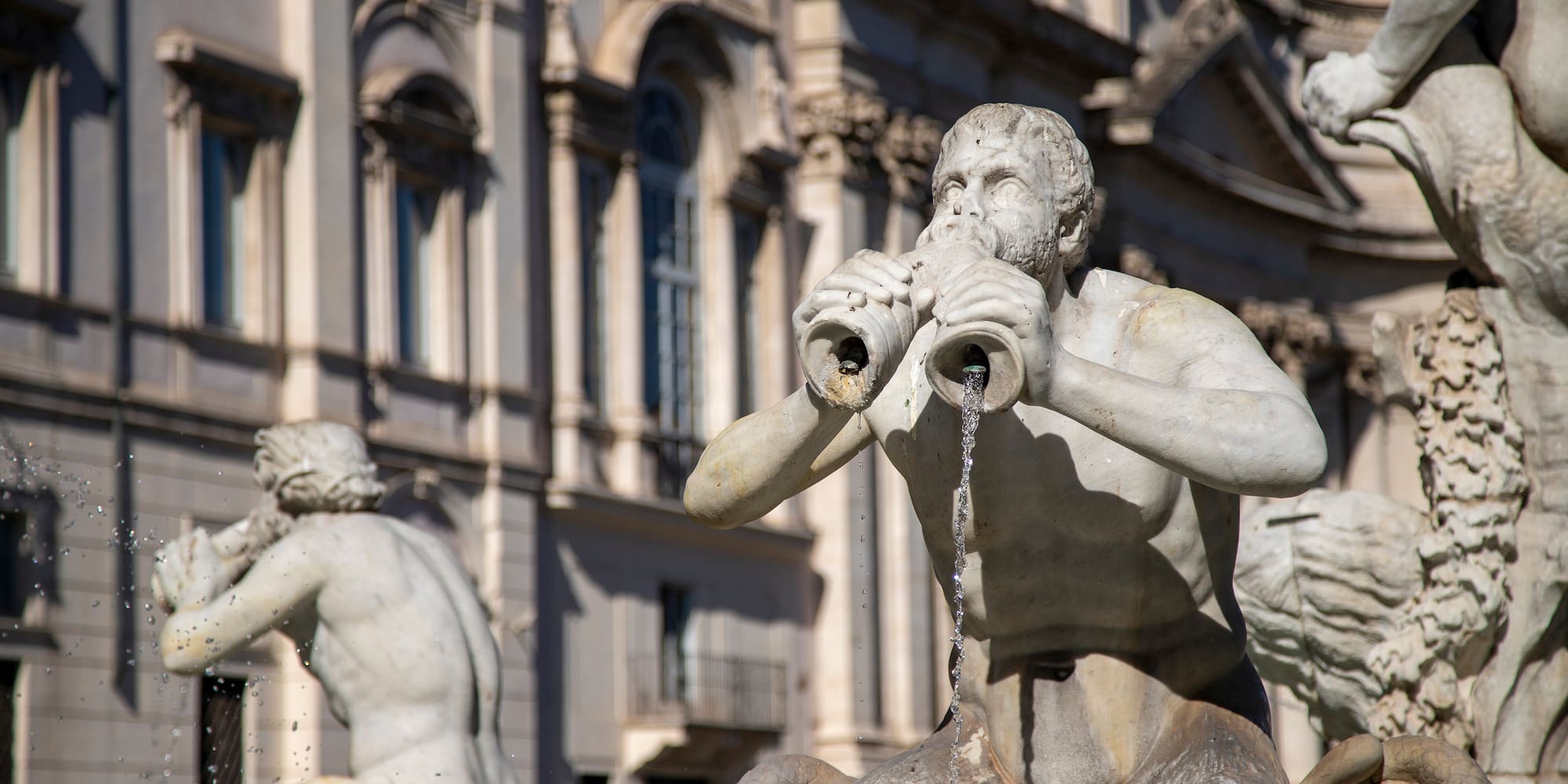 a statue of a man holding a pipe