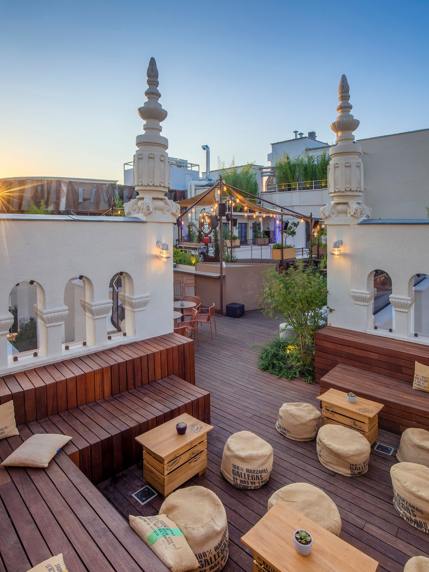 a rooftop patio with tables and chairs