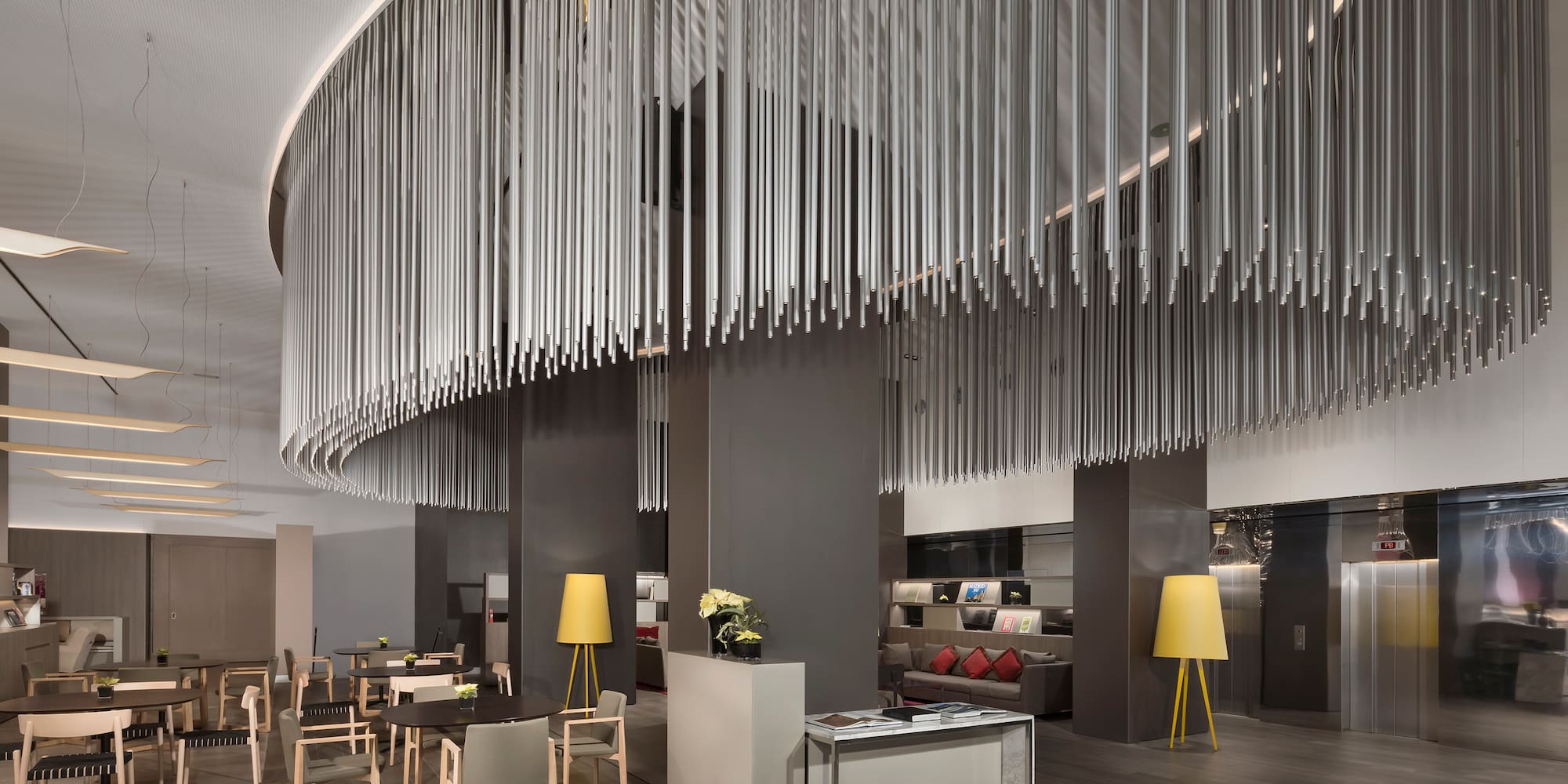 a room with a chandelier and tables