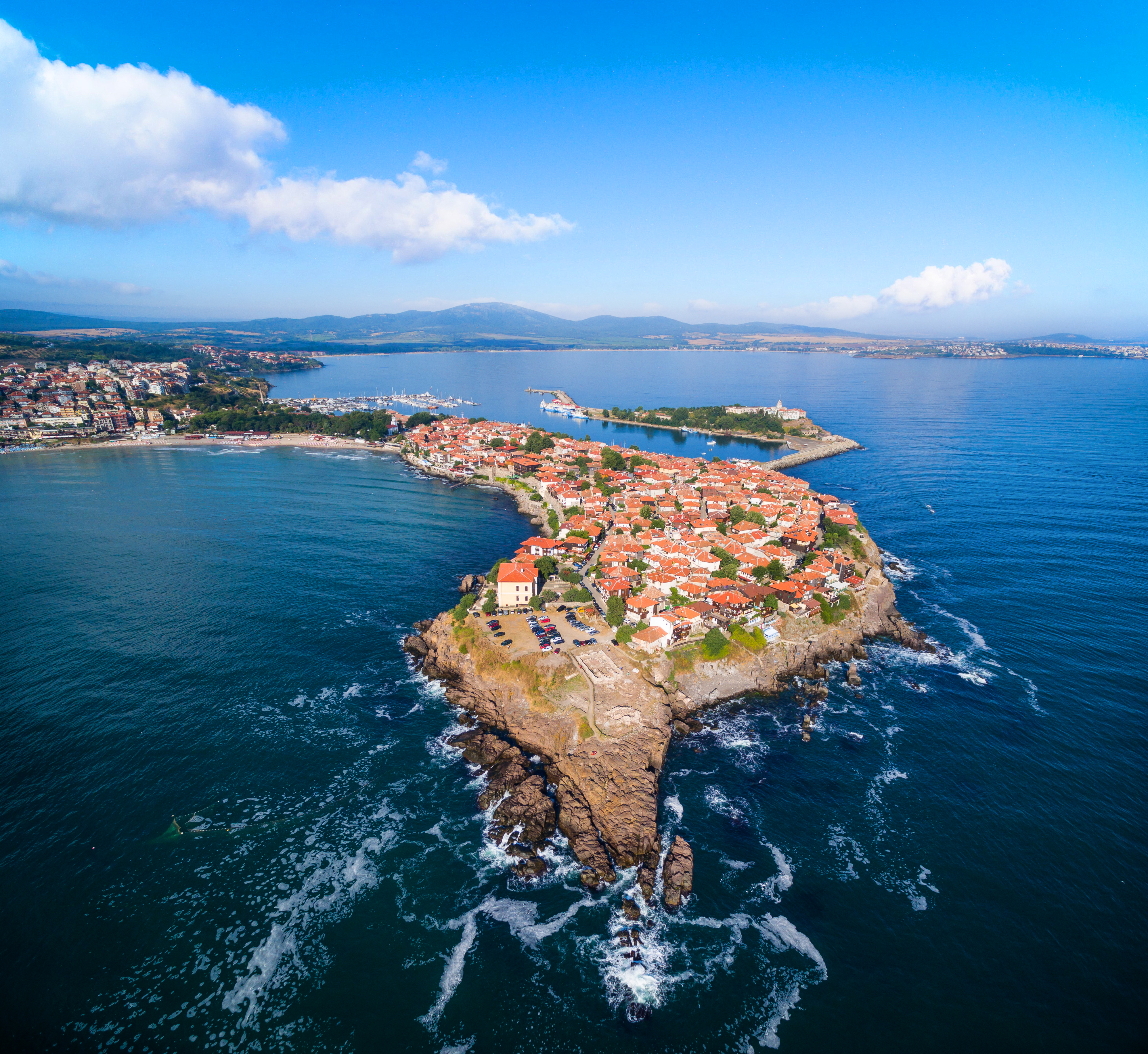 an island with buildings and water in the background