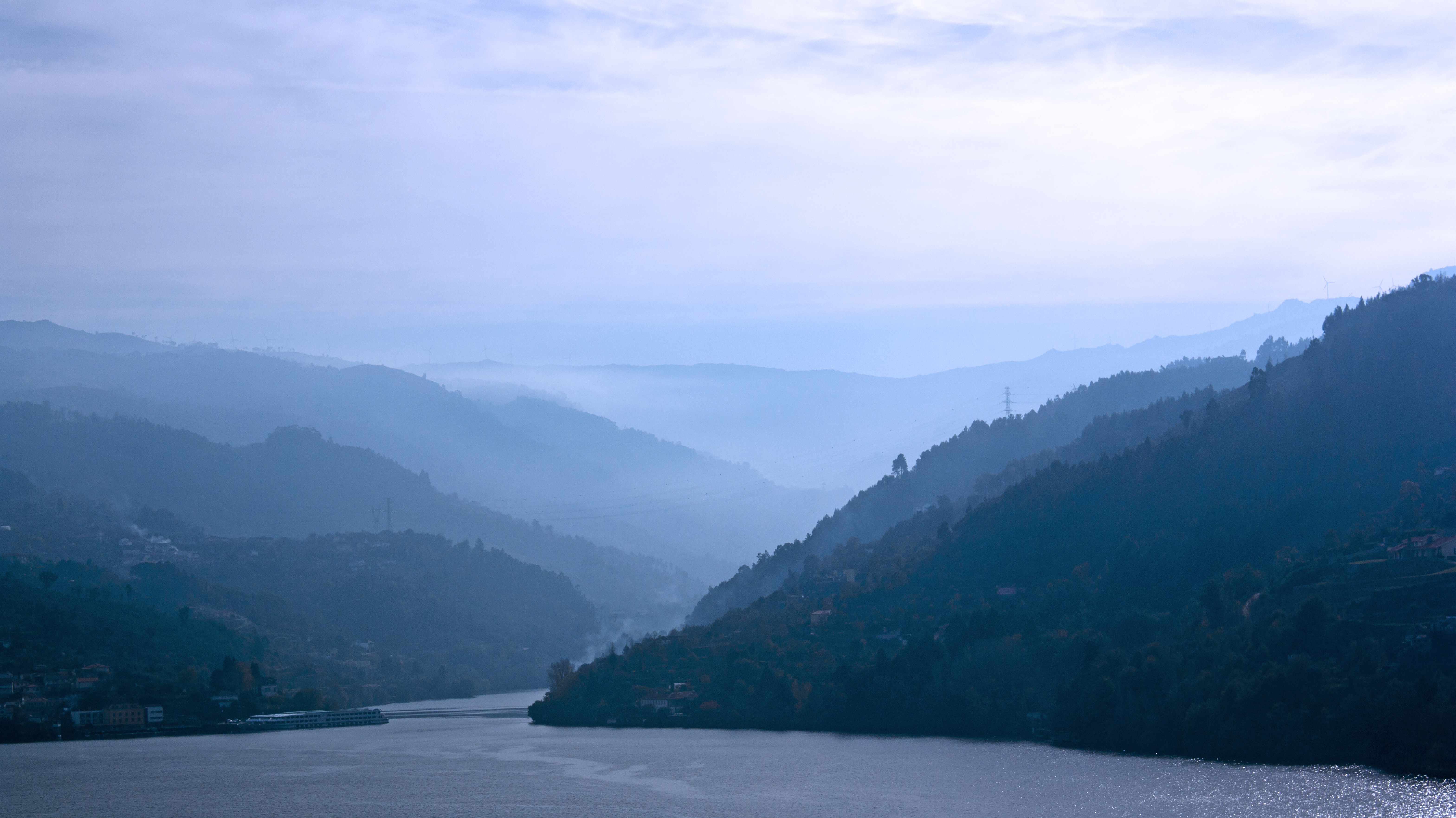 a body of water with a body of water and mountains in the background