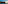 Infinity pool with bay view, boats, cliffside villas, and sunset.