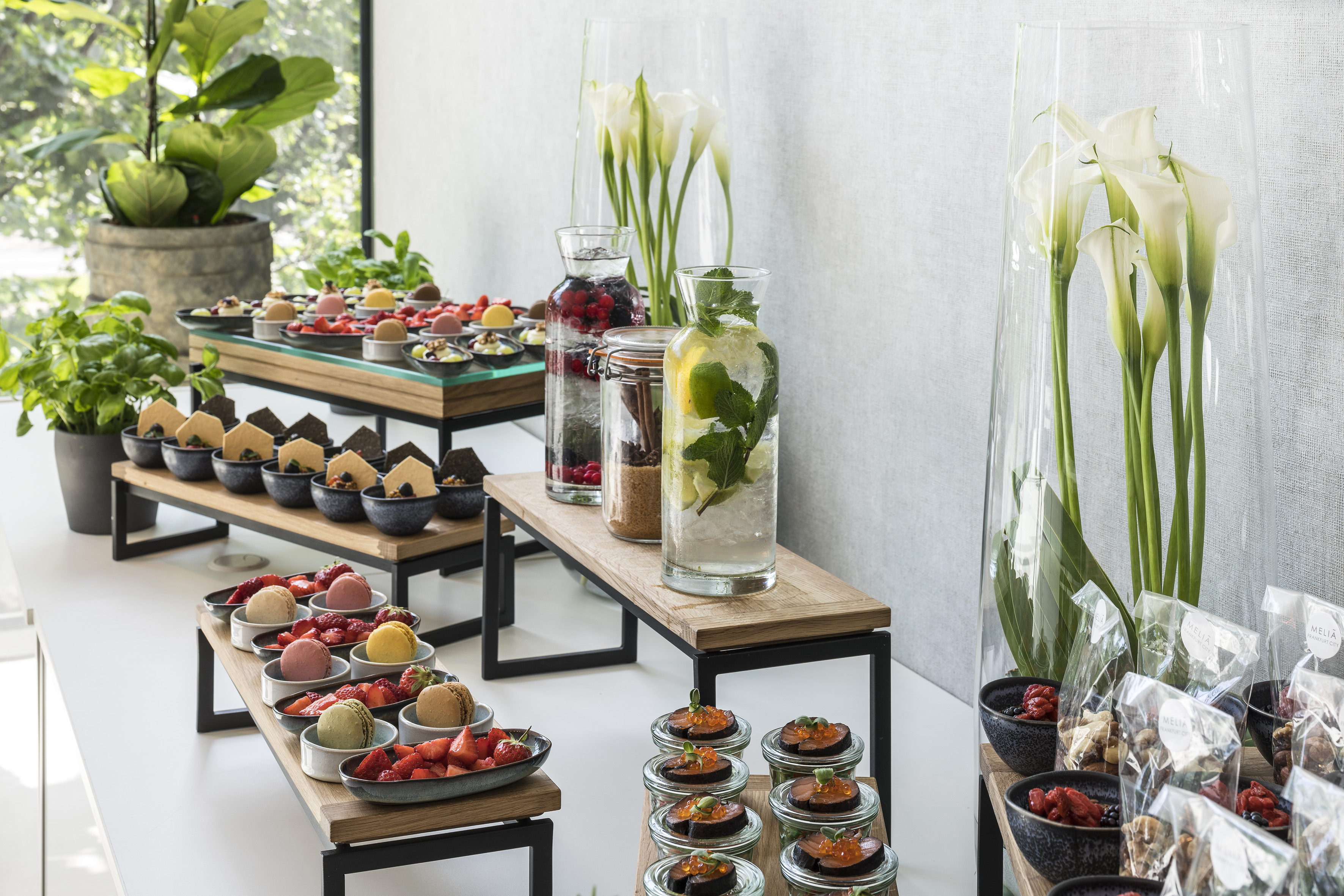 Elegant hotel buffet with desserts, savory bites, and infused water drinks.