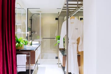 a bathroom with a shower and a bathrobe