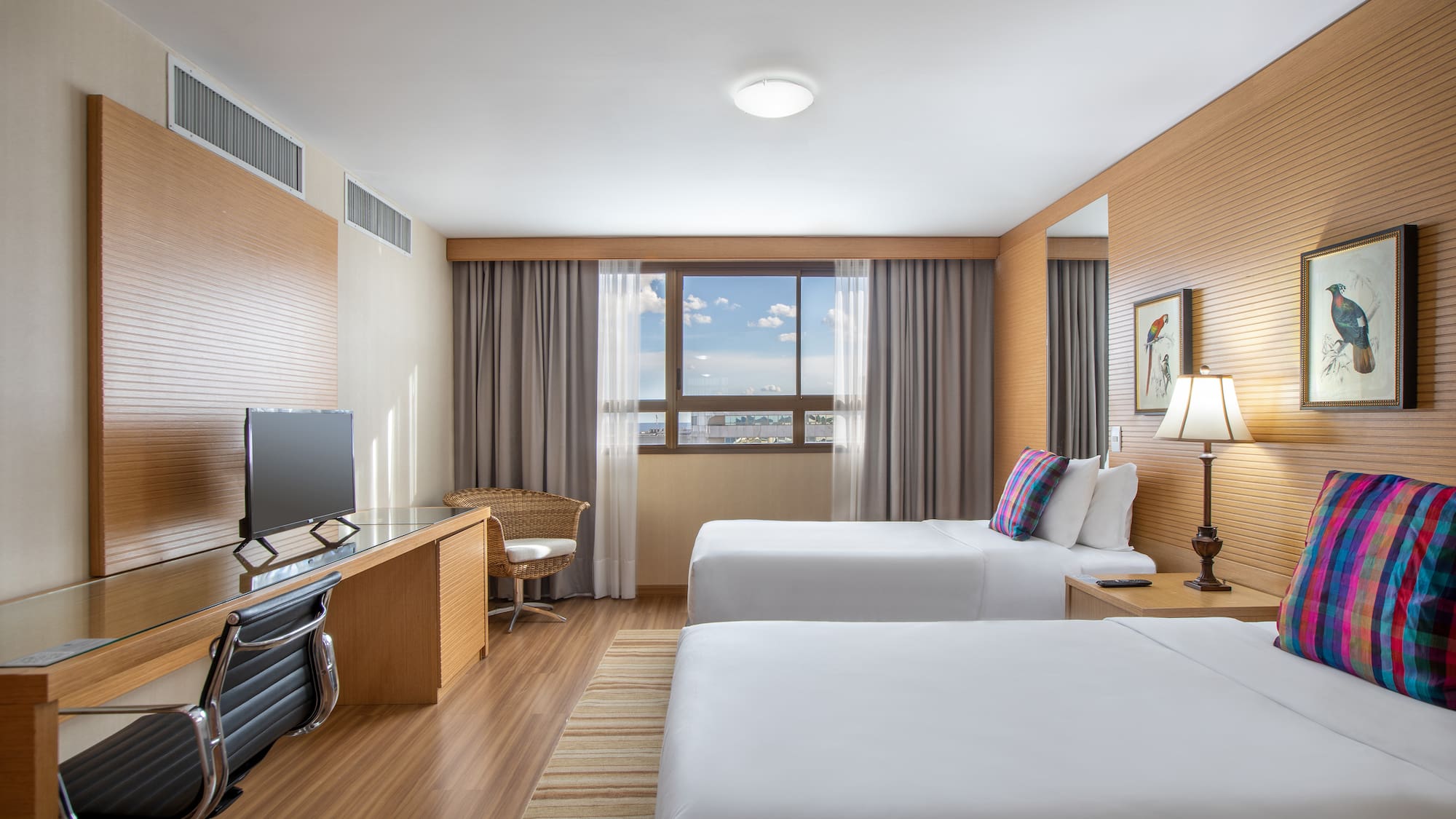 a room with two beds and a desk