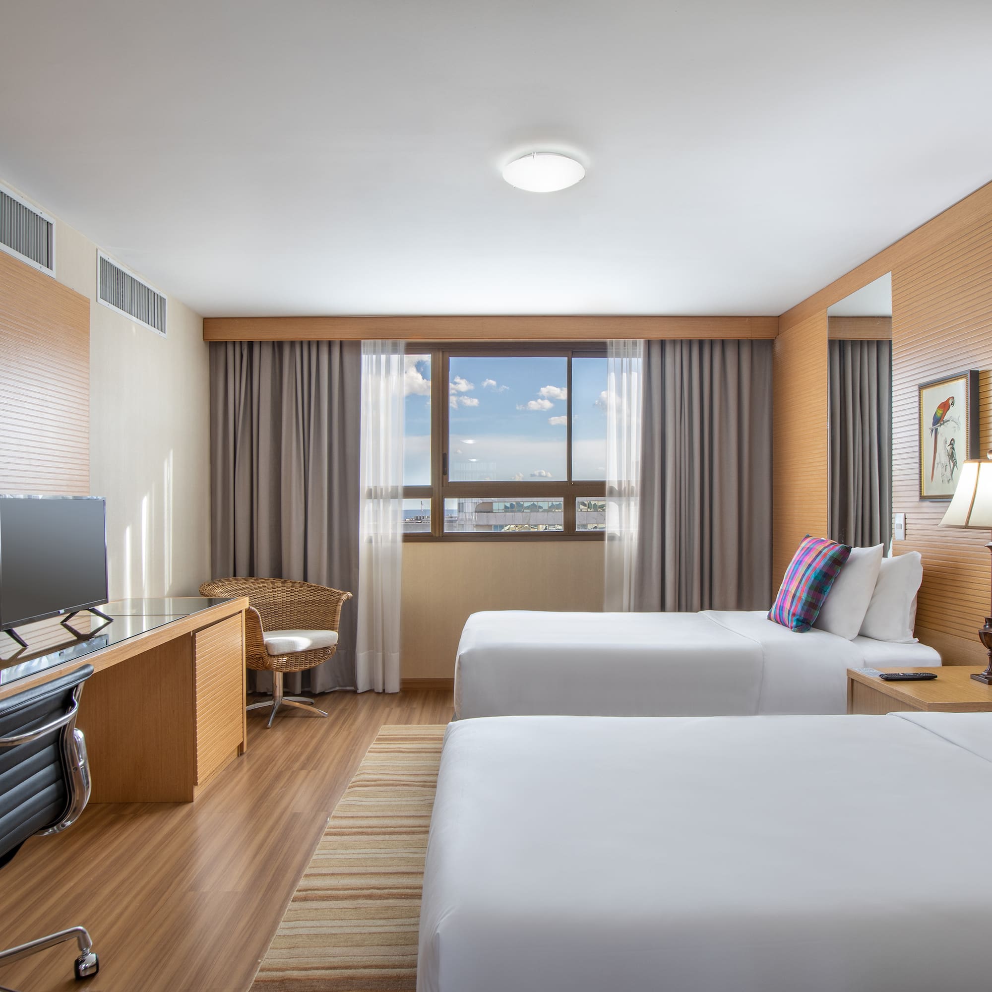 a room with two beds and a desk