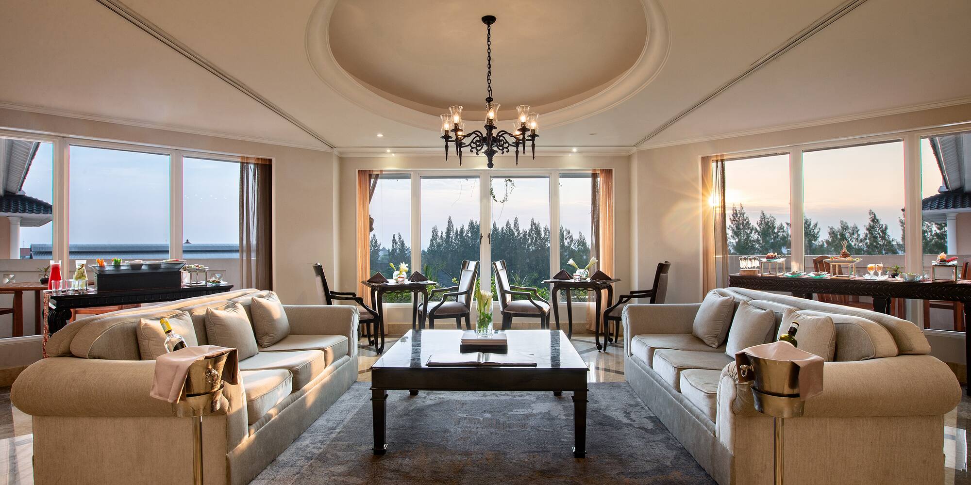 a room with a large chandelier and couches