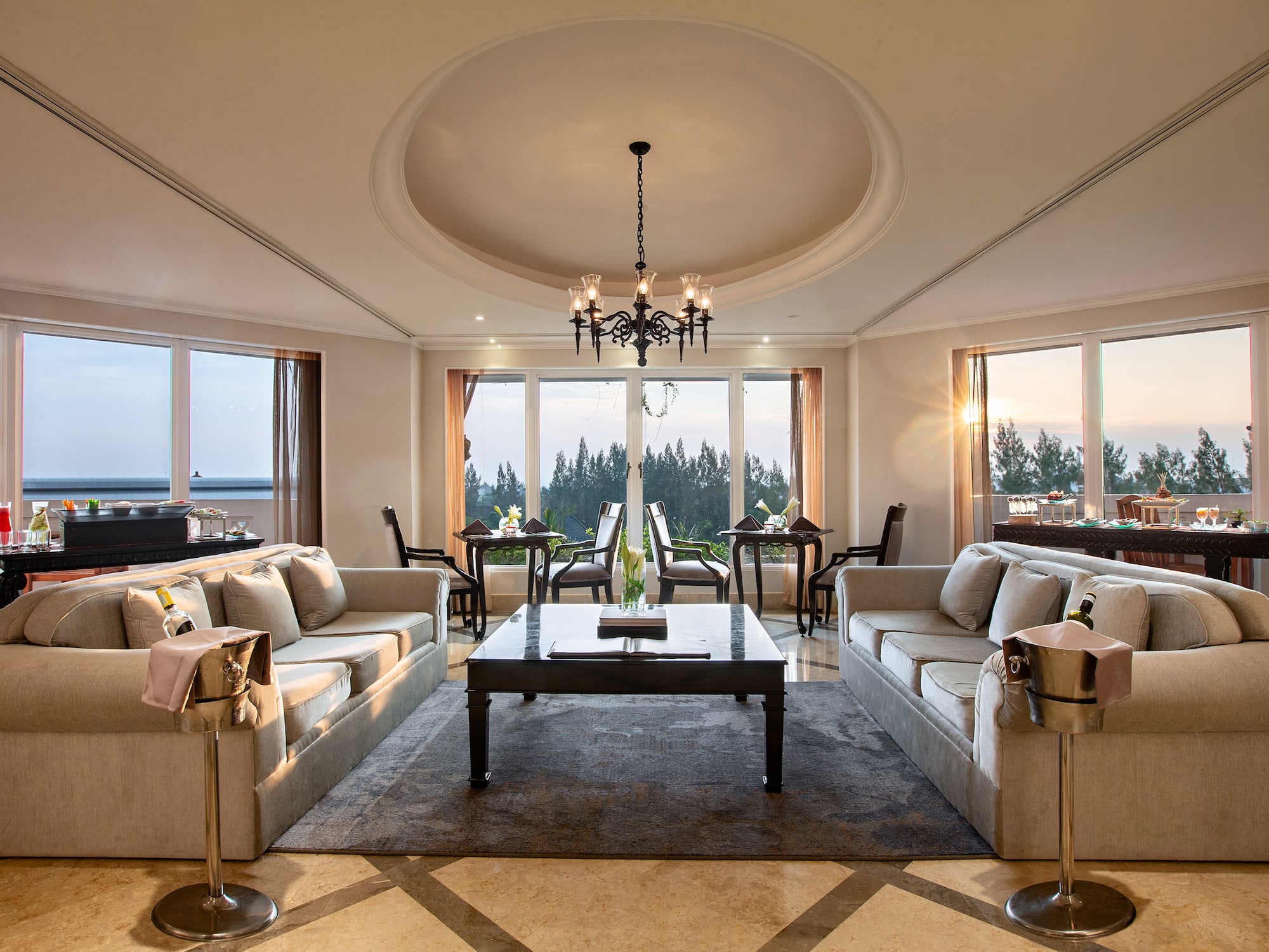 a room with a large chandelier and couches