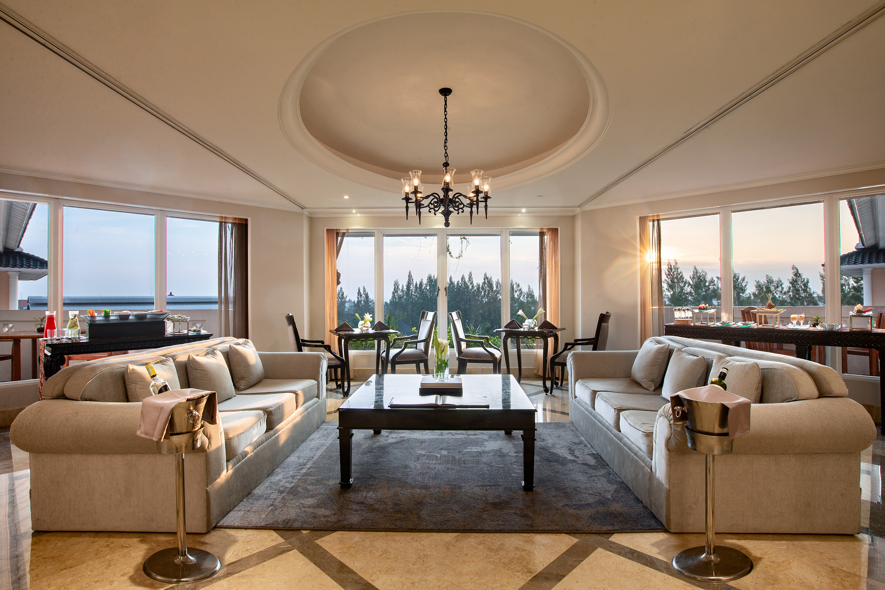 a room with a large chandelier and couches