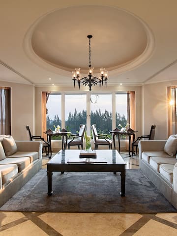 a room with a large chandelier and couches