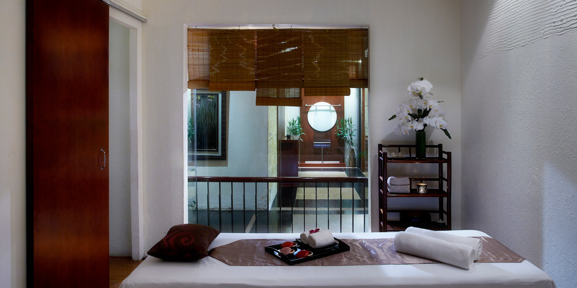 a massage table with towels and a tray on it