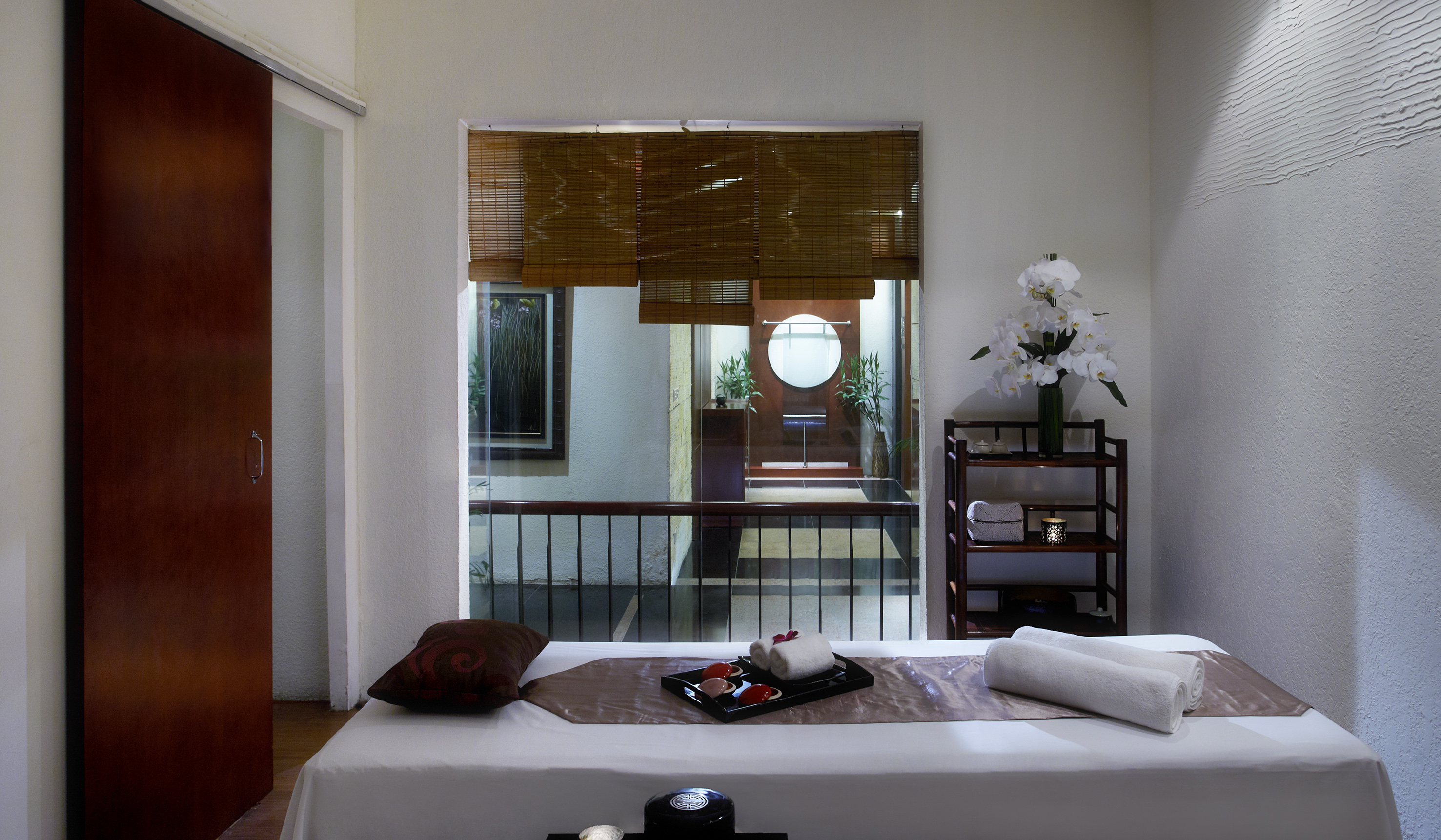 a massage table with towels and a tray on it