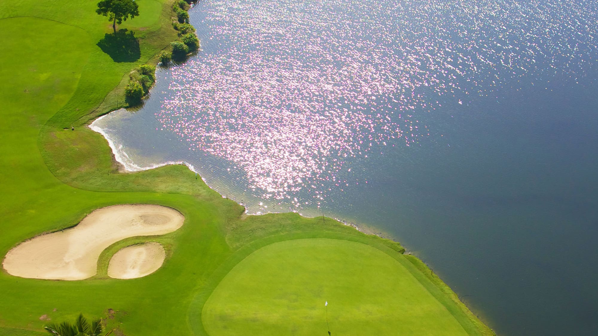 a golf course with a body of water