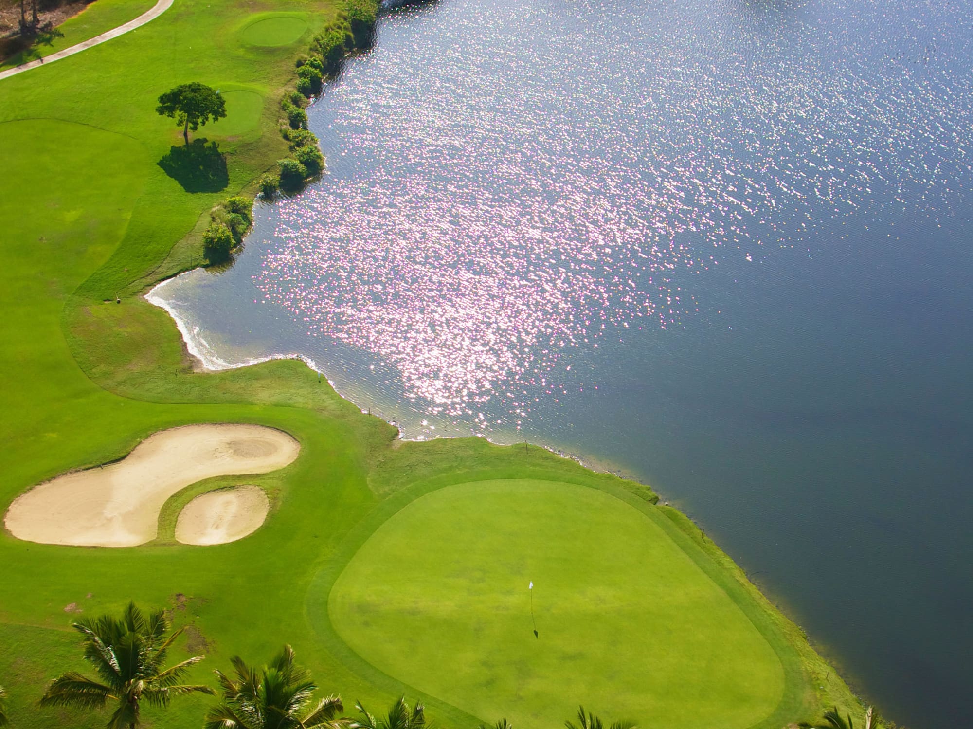 a golf course with a body of water