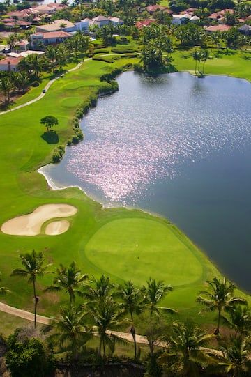 a golf course with a body of water