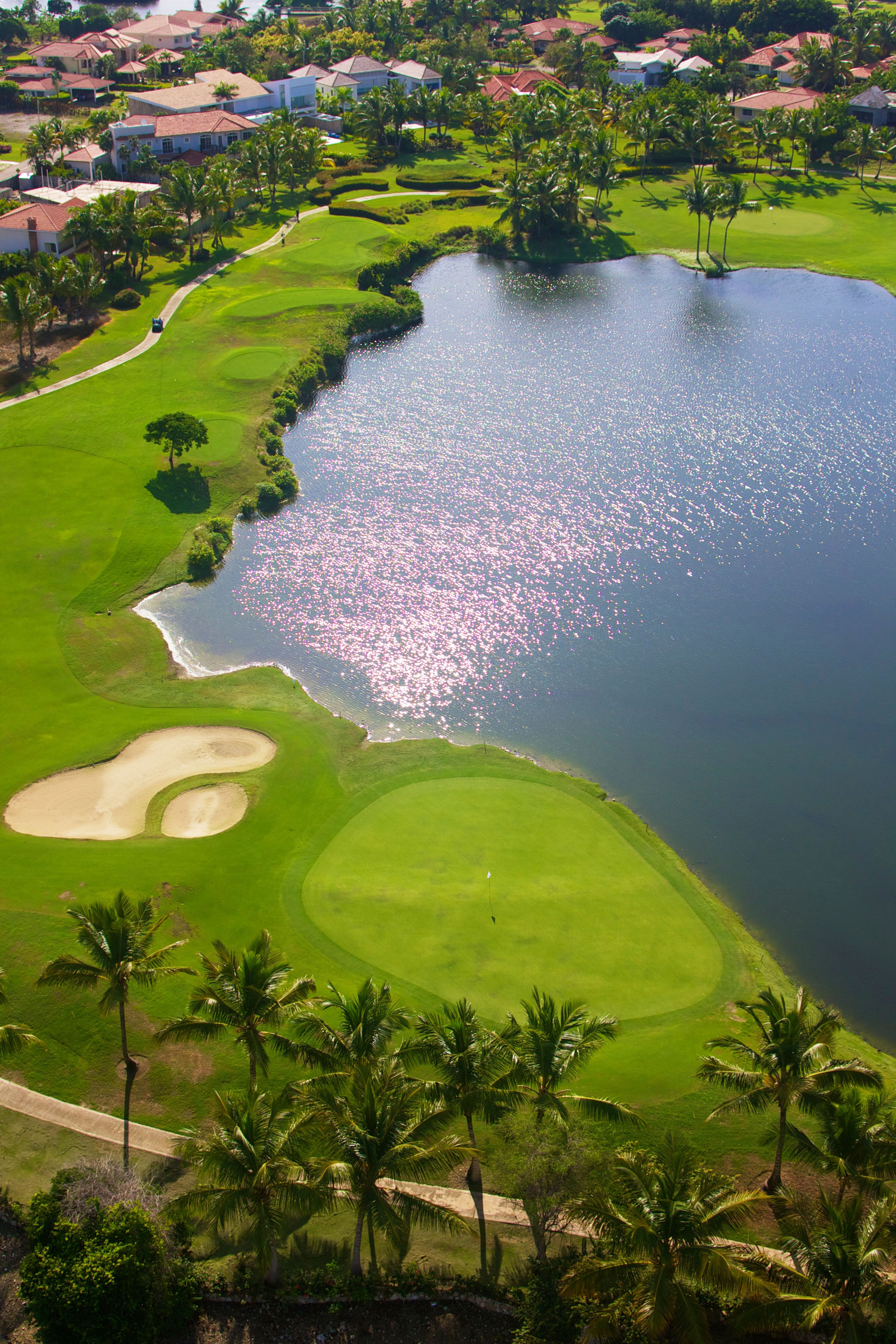 a golf course with a body of water