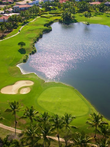 a golf course with a body of water