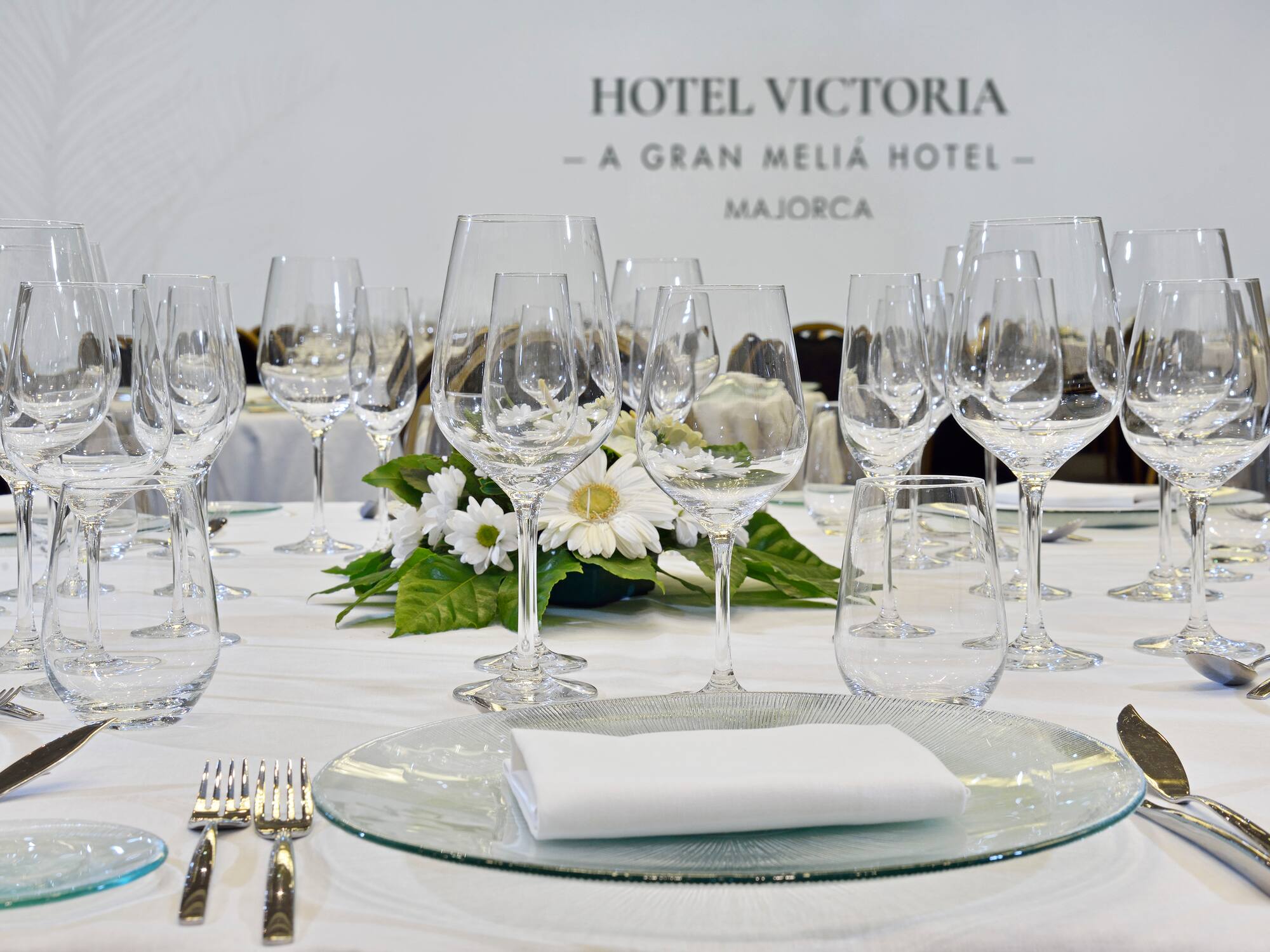 a table set with glasses and a plate of wine
