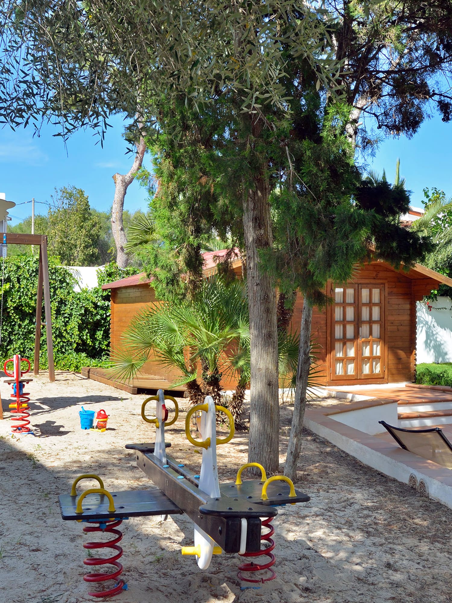 a playground with a slide and a tree
