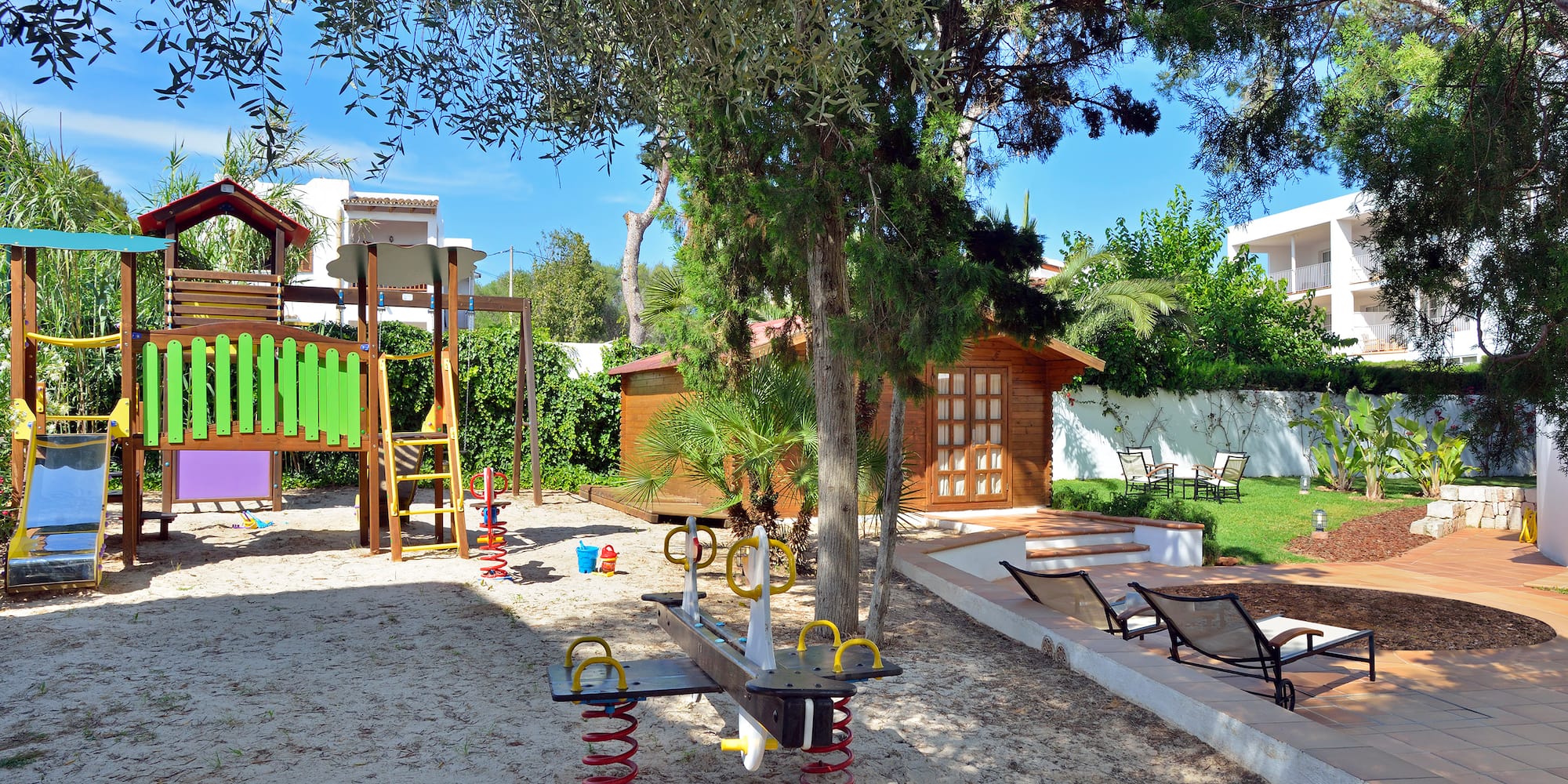 a playground with a slide and a tree