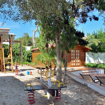 a playground with a slide and a tree