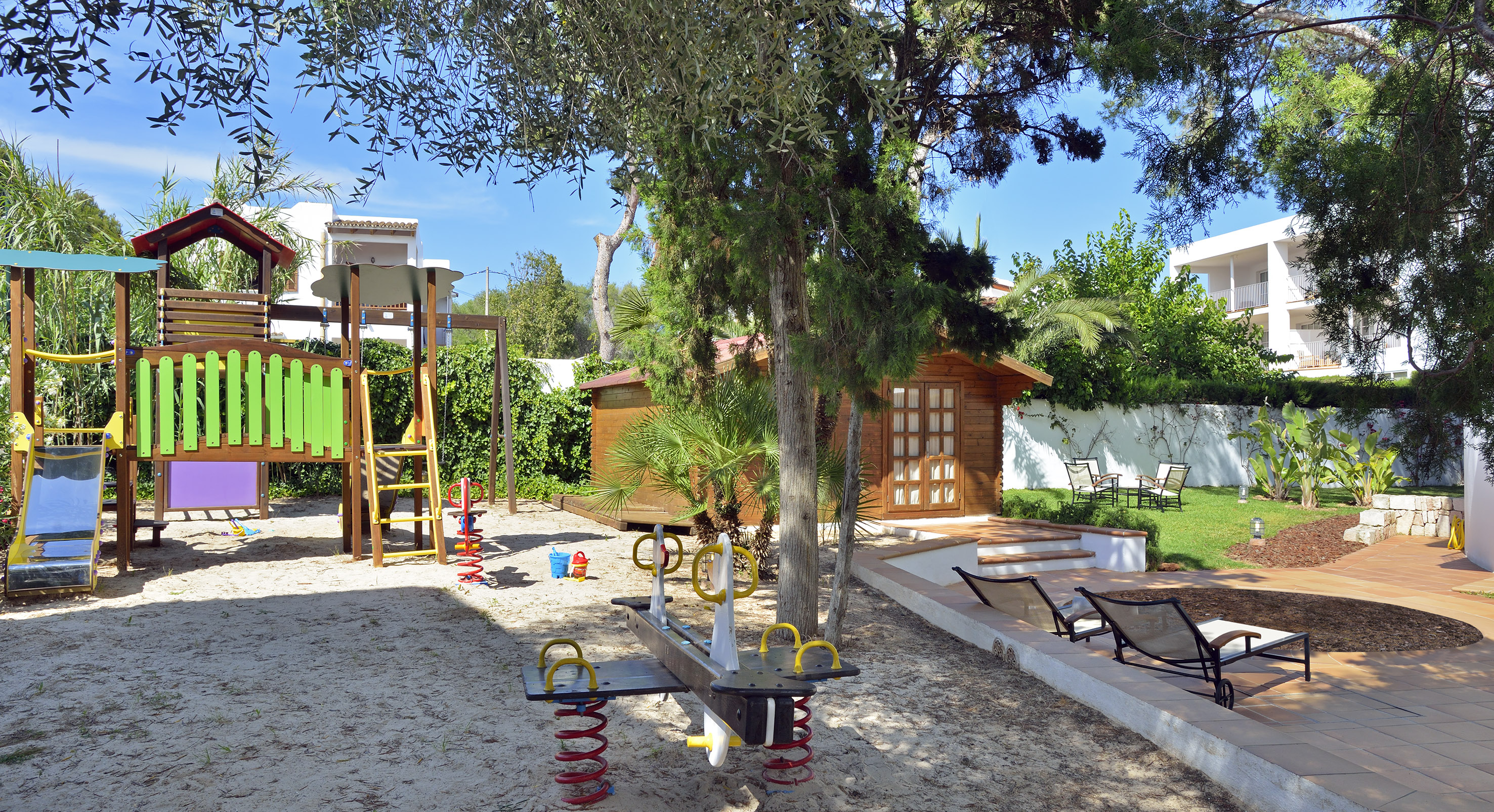 a playground with a slide and a tree