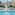 a pool with a couple of beds and a city skyline