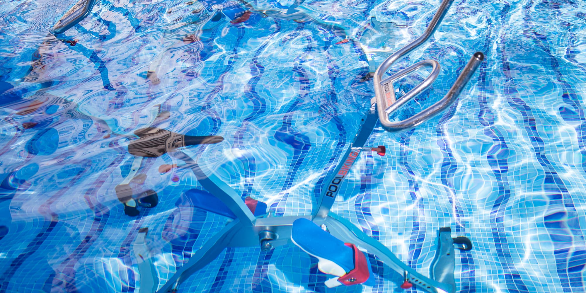 a swimming pool with a bike and ladders