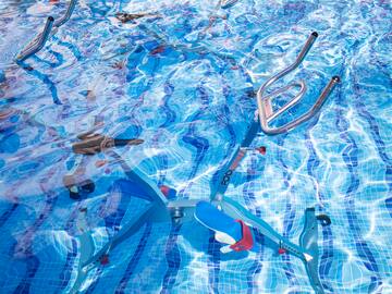 a swimming pool with a bike and ladders