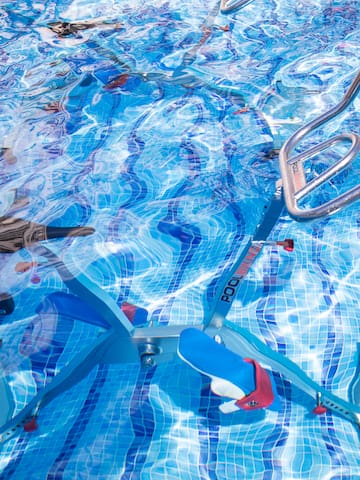 a swimming pool with a bike and ladders