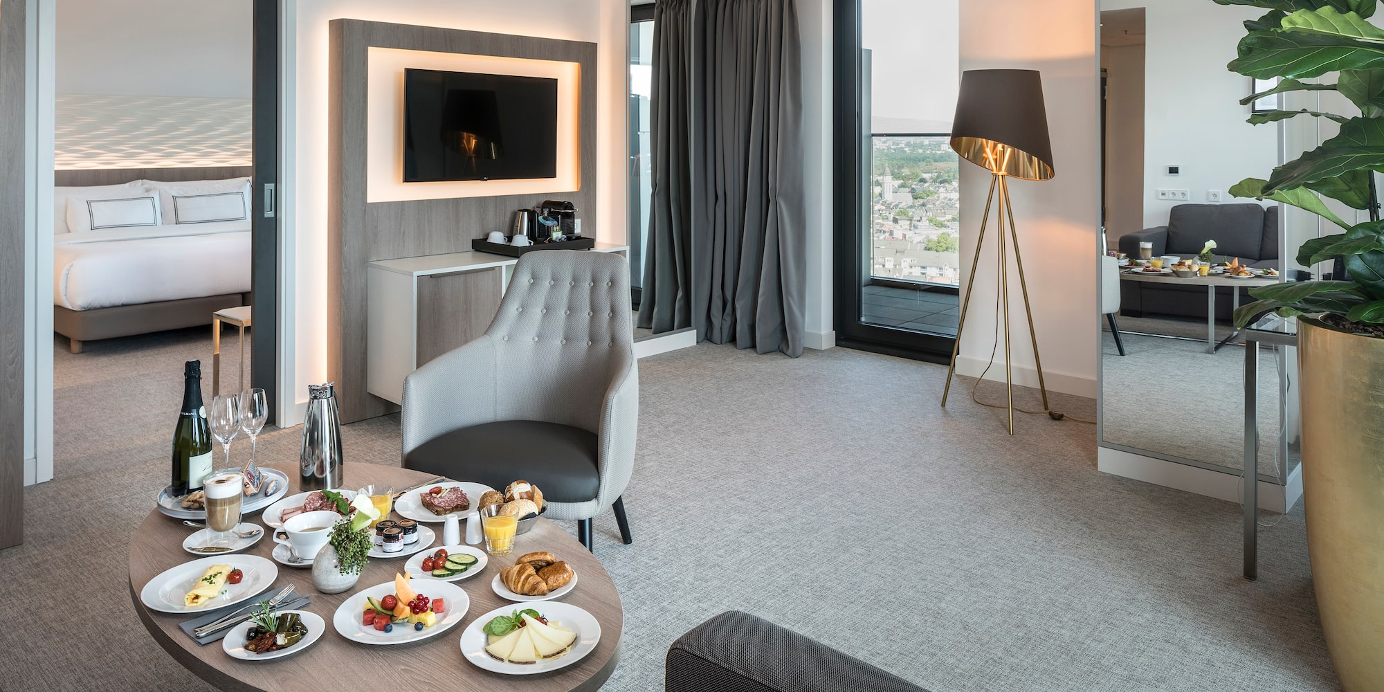 a room with a table of food and a television