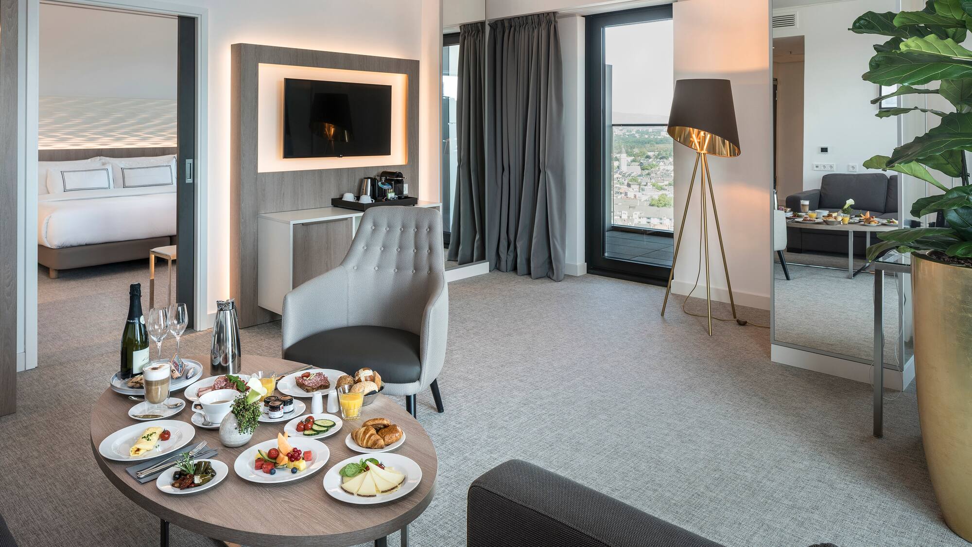 a room with a table of food and a television